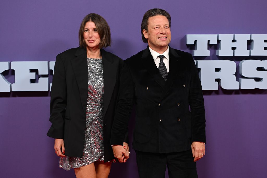 Jools Oliver standing with husband Jamie Oliver