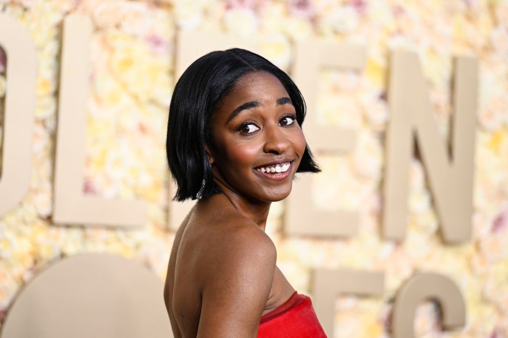 Ayo Edebiri with her hair in a bob smiling at the Golden Globes 