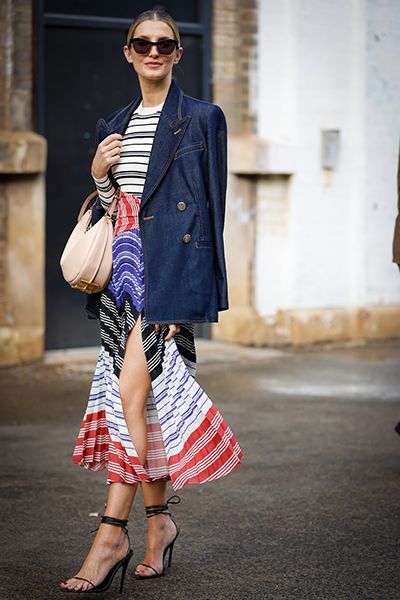 Woman wearing denim jacket with pleated midi