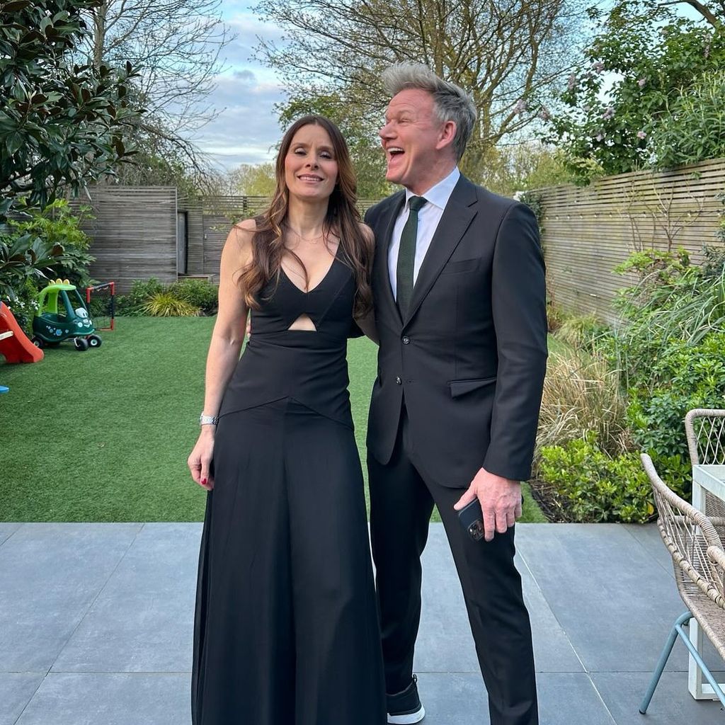 couple posing in black outfits 