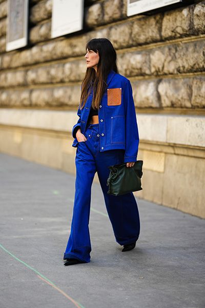 Woman wearing denim jacket with double waistband jeans