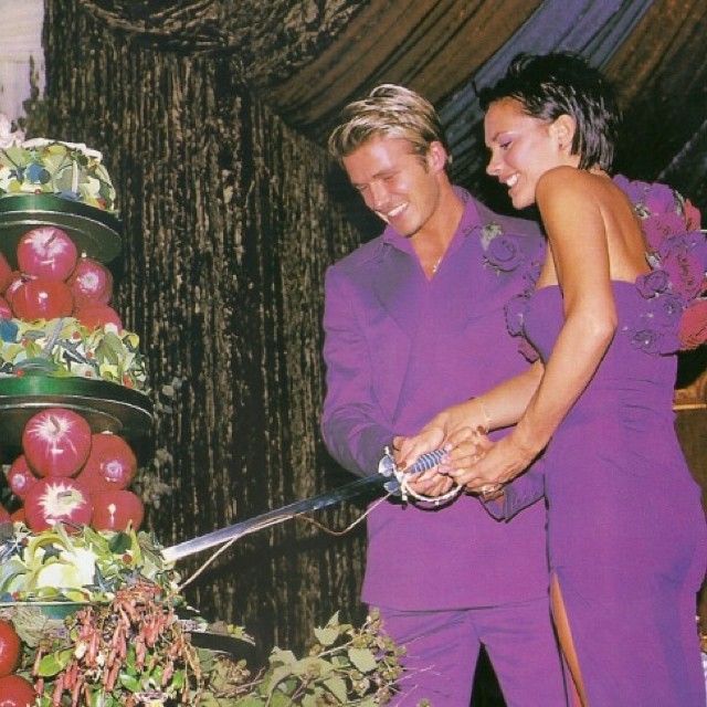 David and Victoria cutting their wedding cake with a sword