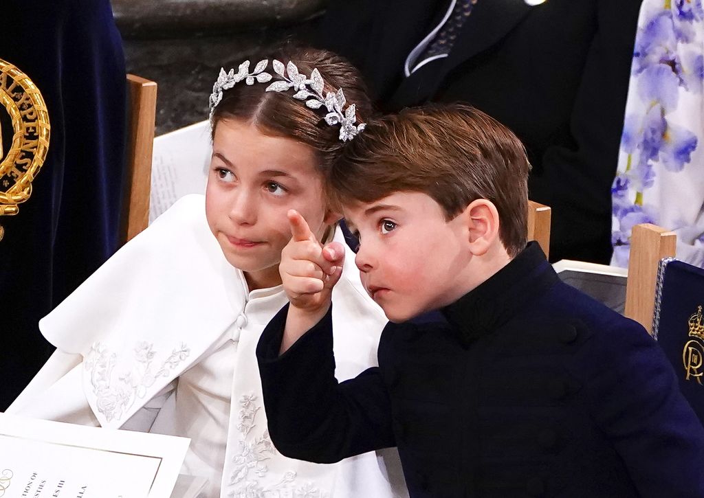 Prince Louis pointing at something in the sky with Princess Charlotte