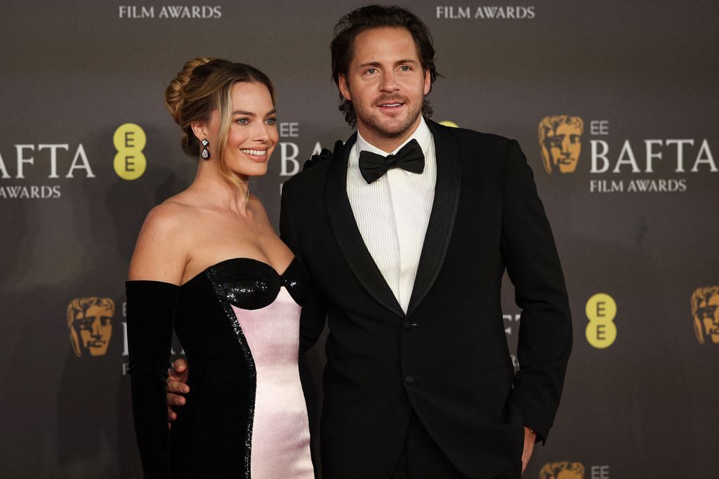 Australian actress Margot Robbie and English film producer Tom Ackerley pose on the red carpet upon arrival at the BAFTA British Academy Film Awards at the Royal Festival Hall, Southbank Centre, in London, on February 18, 2024