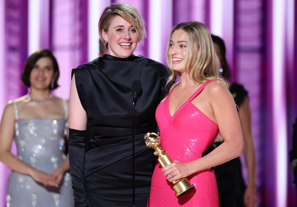 Greta Gerwig and Margot Robbie accepts the award for Cinematic and Box Office Achievement for "Barbie" at the 81st Golden Globe Awards held at the Beverly Hilton Hotel on January 7, 2024 in Beverly Hills, California.