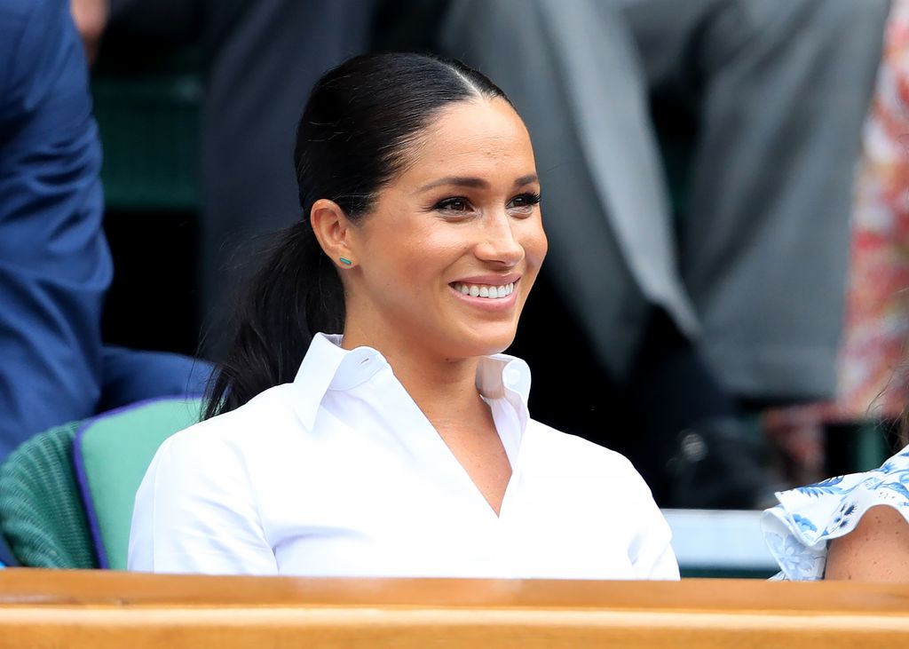 Meghan markle smiling in crisp white shirt