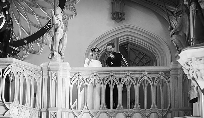 Meghan and Harry toasting on the balcony inside St George's Hall at royal wedding