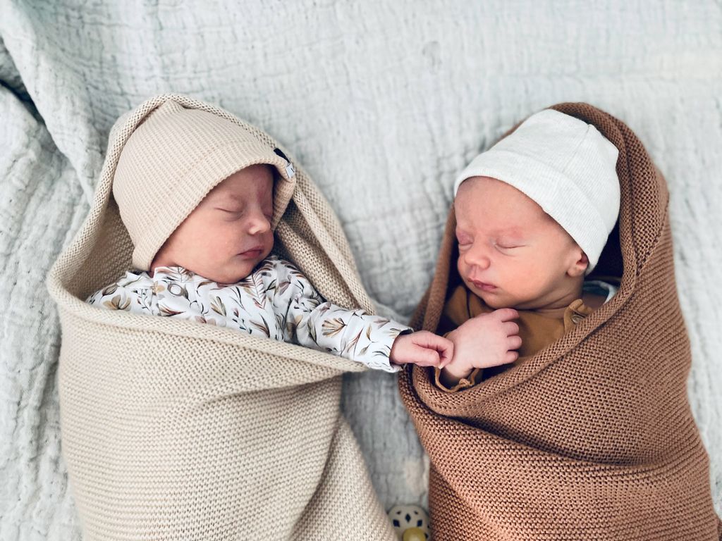 Newborn babies sleeping beside each other