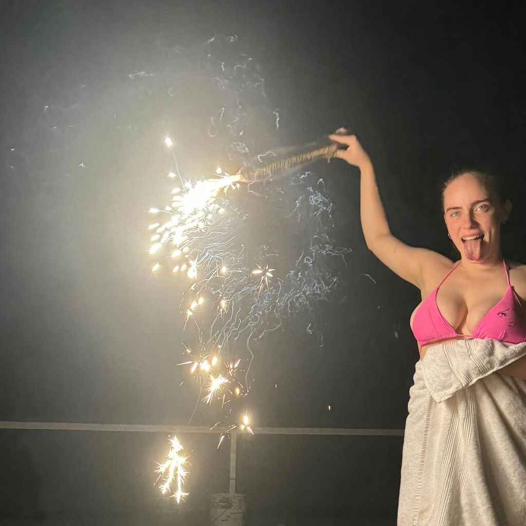 Billie Eilish wears a bikini and holds a sparkler while celebrating 4th of July weekend in a photo shared on Instagram