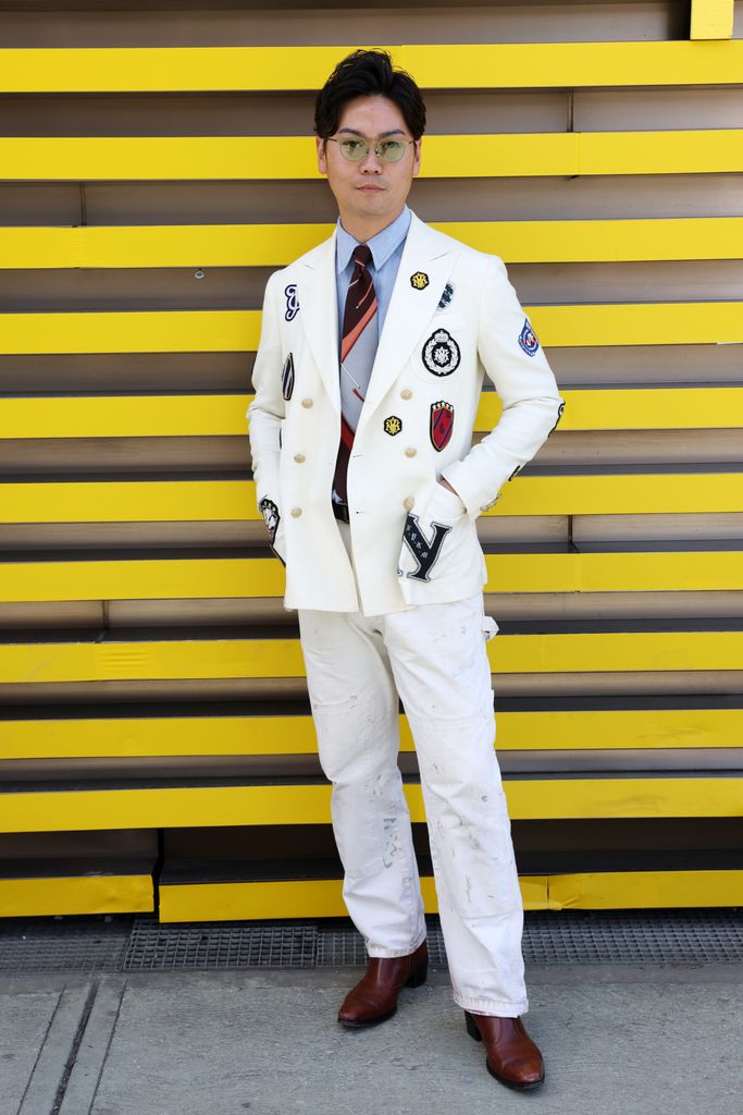 A guest wears a white blazer during Pitti Immagine Uomo 106 on June 12, 2024 