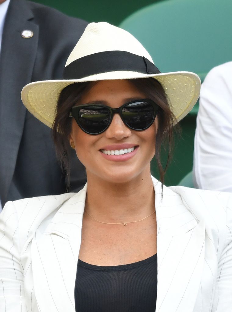 meghan markle in straw hat and sunglasses