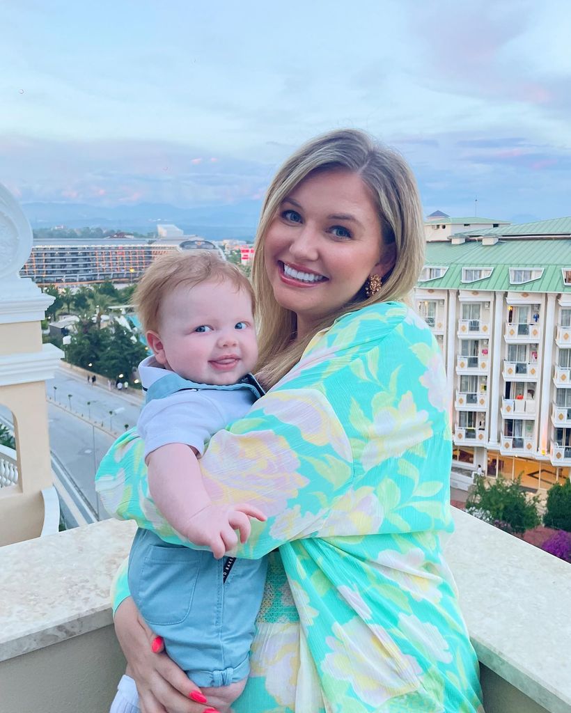 amy on balcony holding Stanley