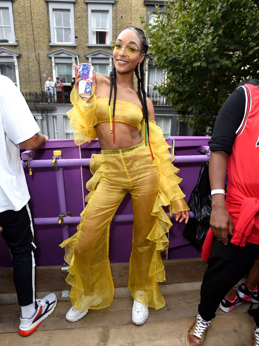 Supermodel Jourdan Dunn wearing sheer, yellow ruffle ensemble  