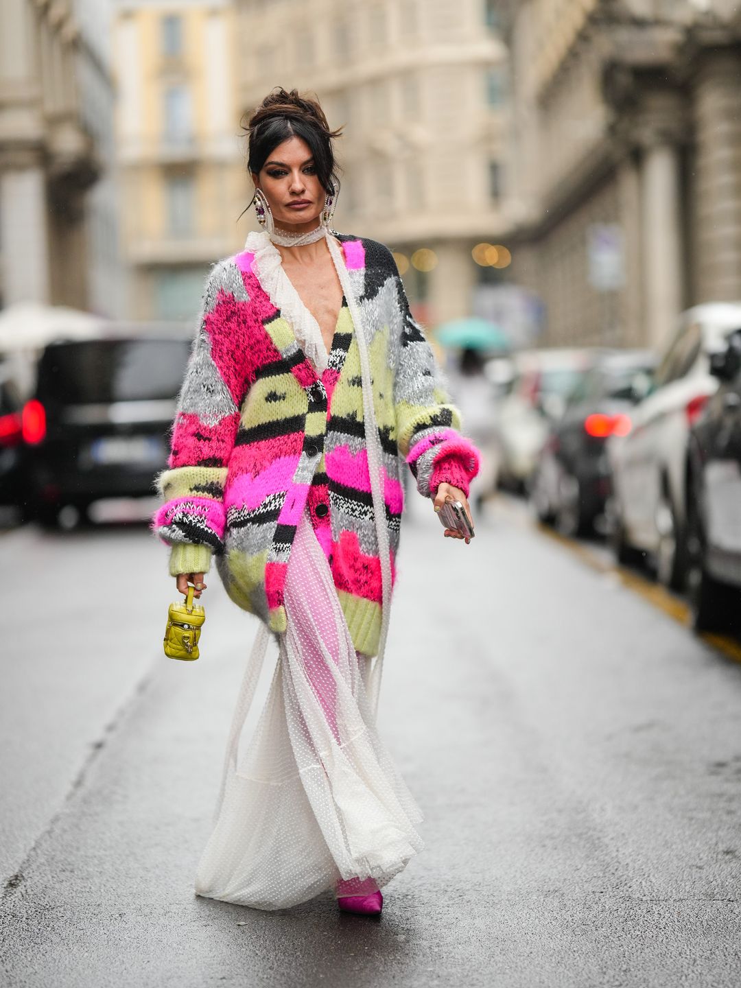 Angela Rozas Saiz wearing a vibrant cardigan over a sheer dress 