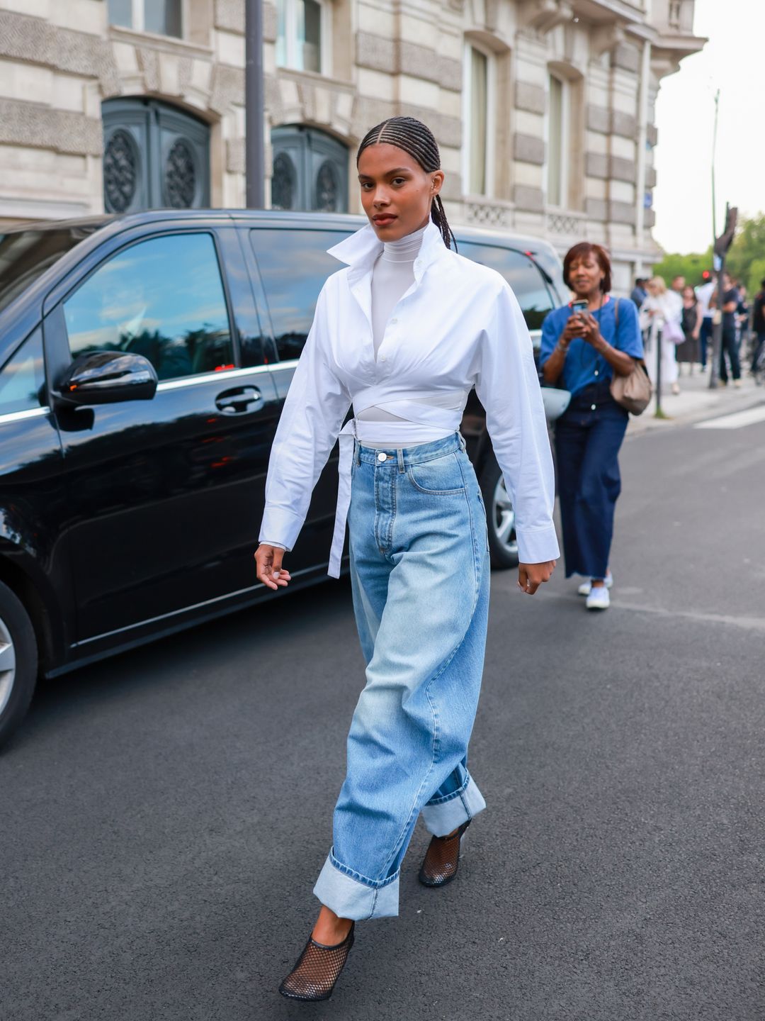 Tina Kunakey opted for cuffed jeans alongside mesh sandals.