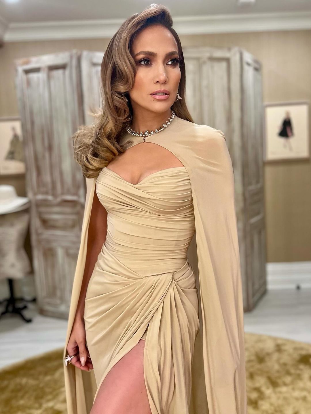 Jennifer Lopez wears a beige gown and cape look on her Instagram