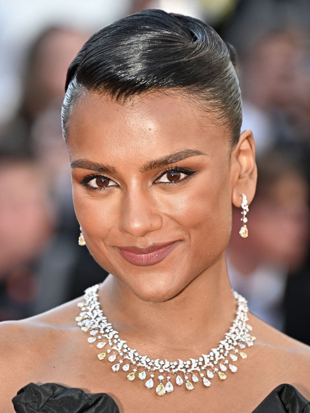 Simone Ashley at Cannes in a black strapless gown 