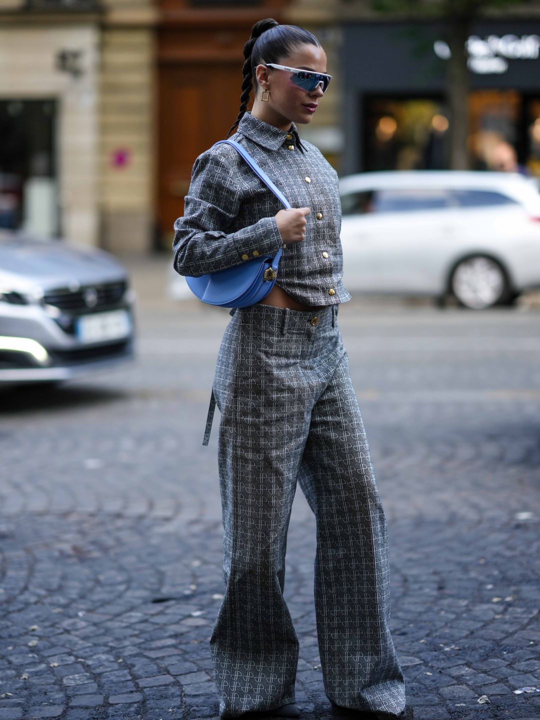 A guest sported a monogram co-ord with racer shades and a blue shoulder bag.