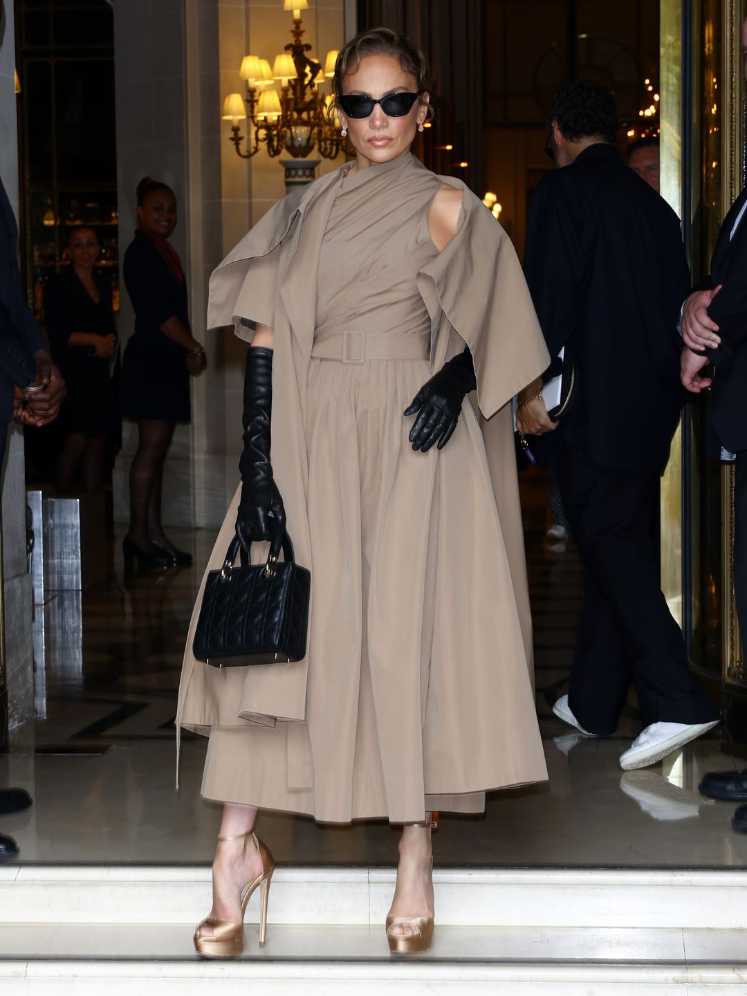 A pair of leather gloves and a Lady Dior bag complemented the Dior ensemble