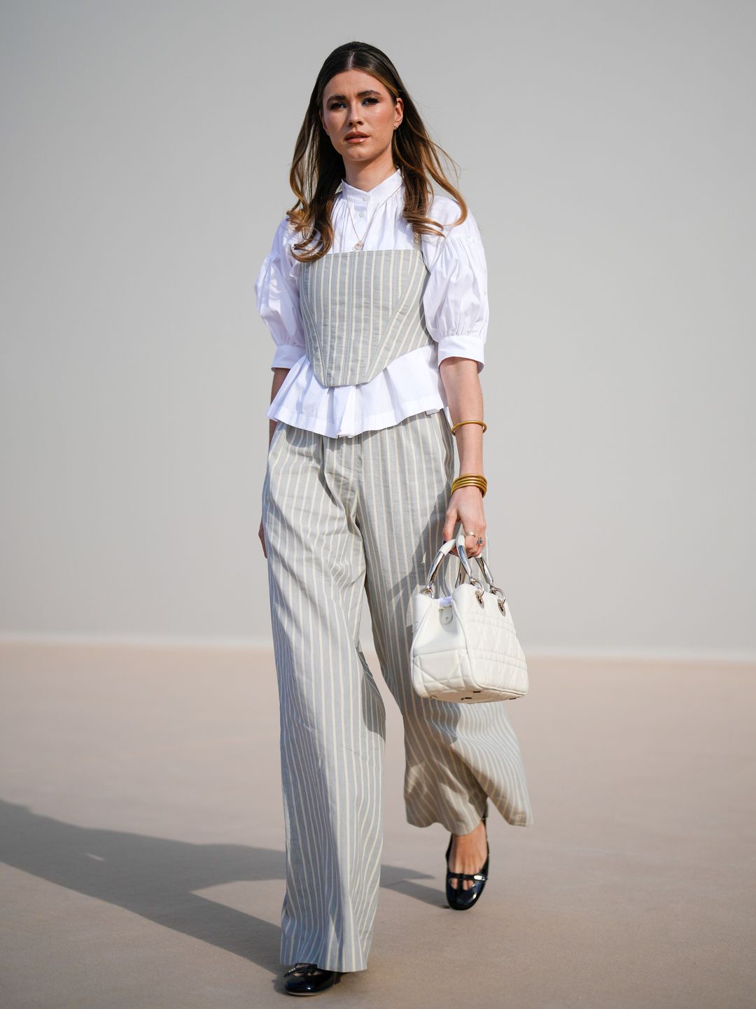 Zita D'Hauteville wearing a corset over a shirt 