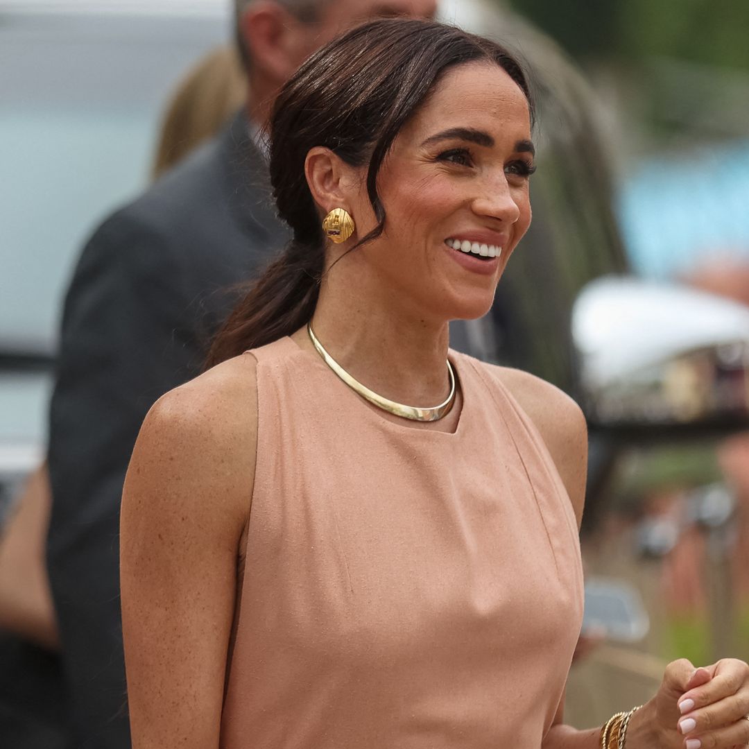 Meghan Markle is perfectly poised in backless waist-cinching look with fairytale updo