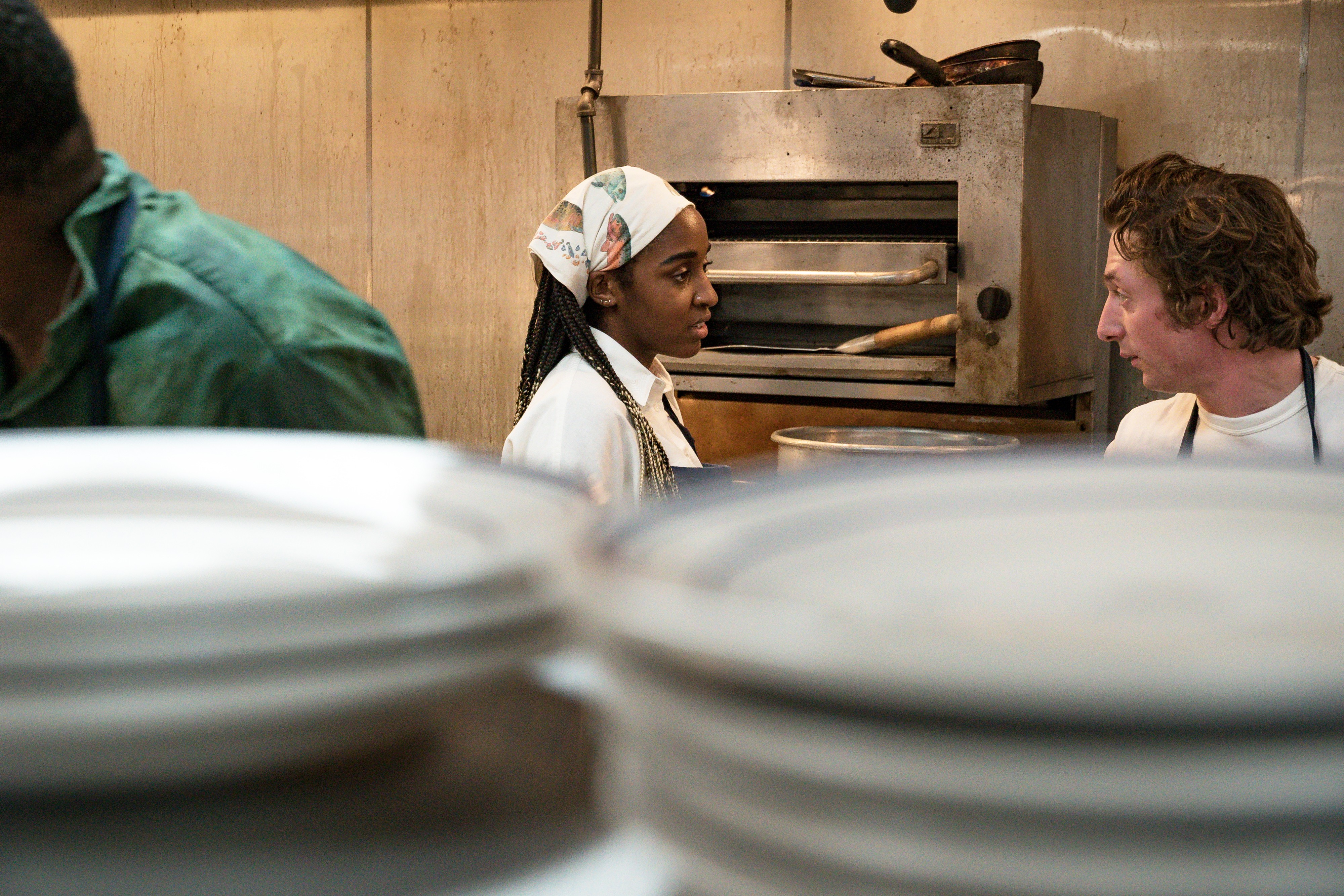 Sydney and Carmen talking in the kitchen