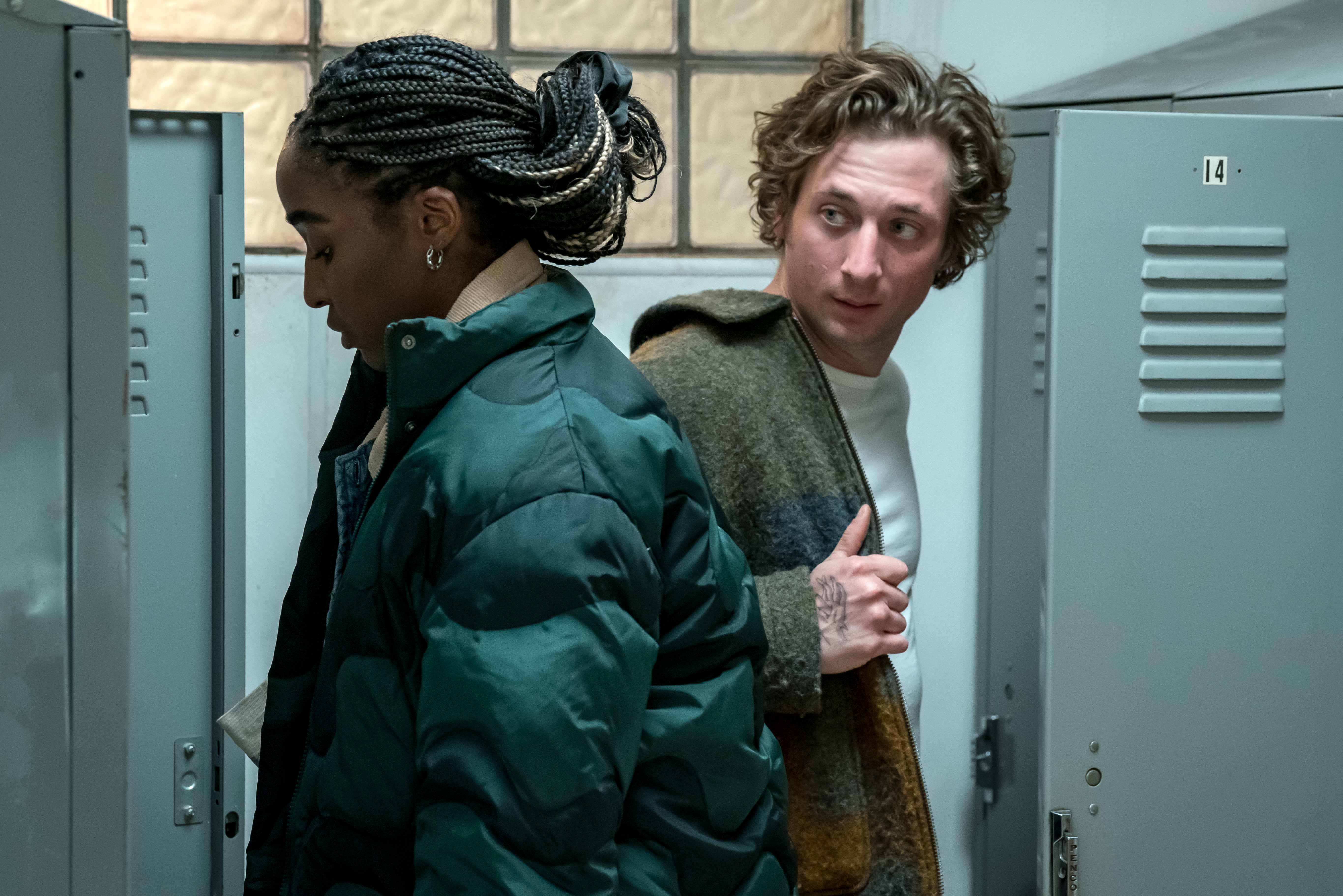 Jeremy Allen White as Carmen “Carmy” Berzatto and Ayo Edebiri as Sydney Adamu in The Bear, standing in a locker room