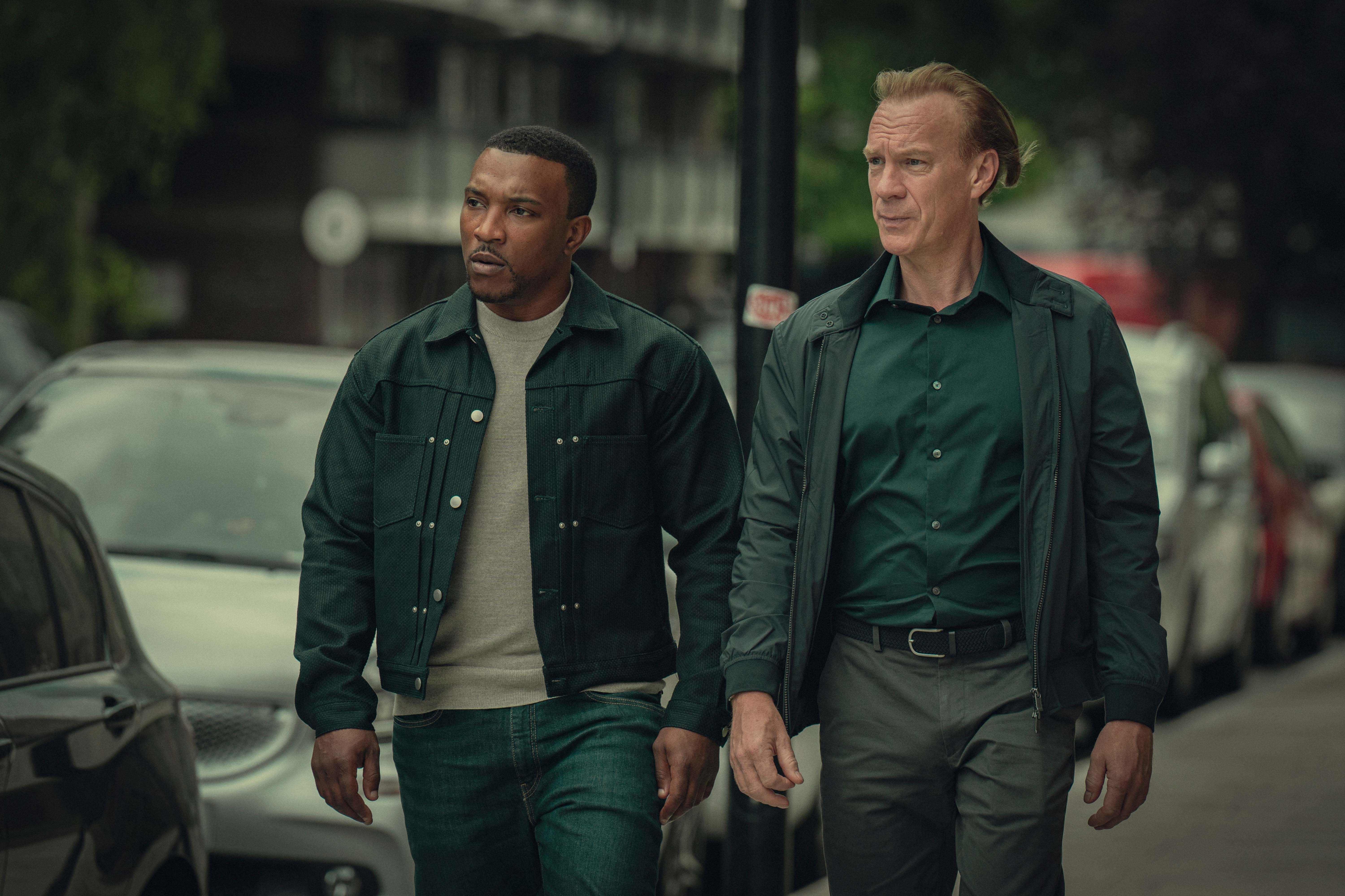 Ashley Walters as Dushane and Shaun Dingwall as Jeffrey in Top Boy walking together down a street