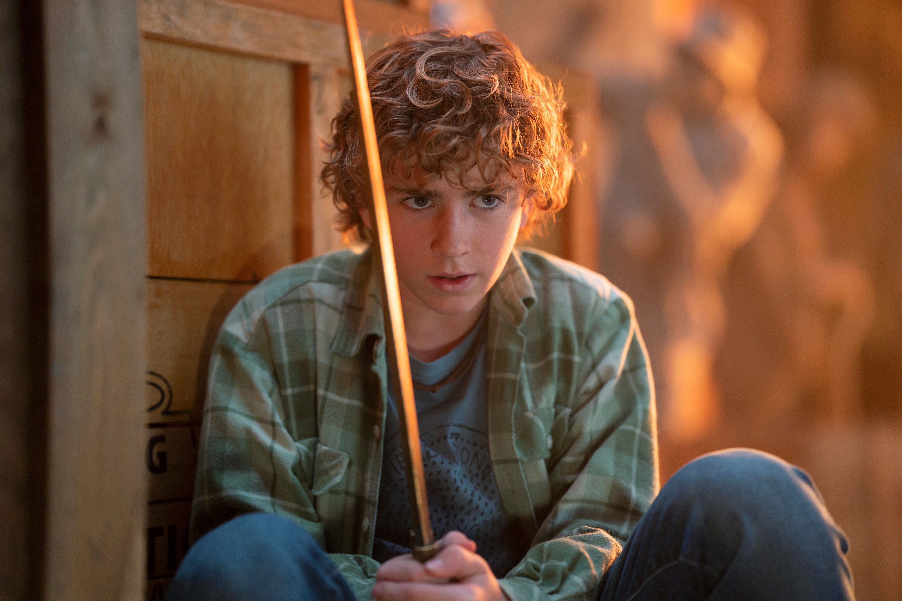 Walker Scobell as Percy Jackson in Percy Jackson and the Olympians holding a sword