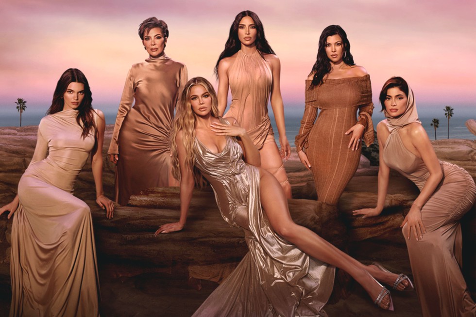 The Kardashian-Jenner family all wearing tanned clothing, looking ahead with pout expressions.