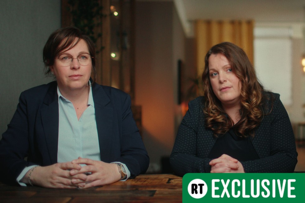 Two women sat next to each other at a table, with their hands on the table. There is a green RT EXCLUSIVE label in the corner.