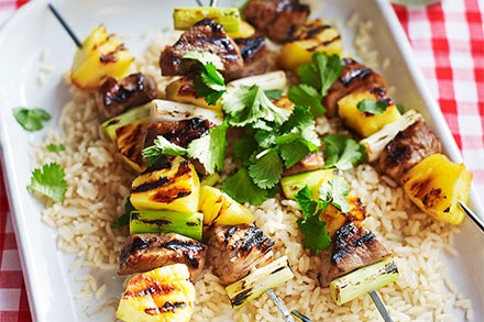 Pineapple & pork skewers served on a bed of rice