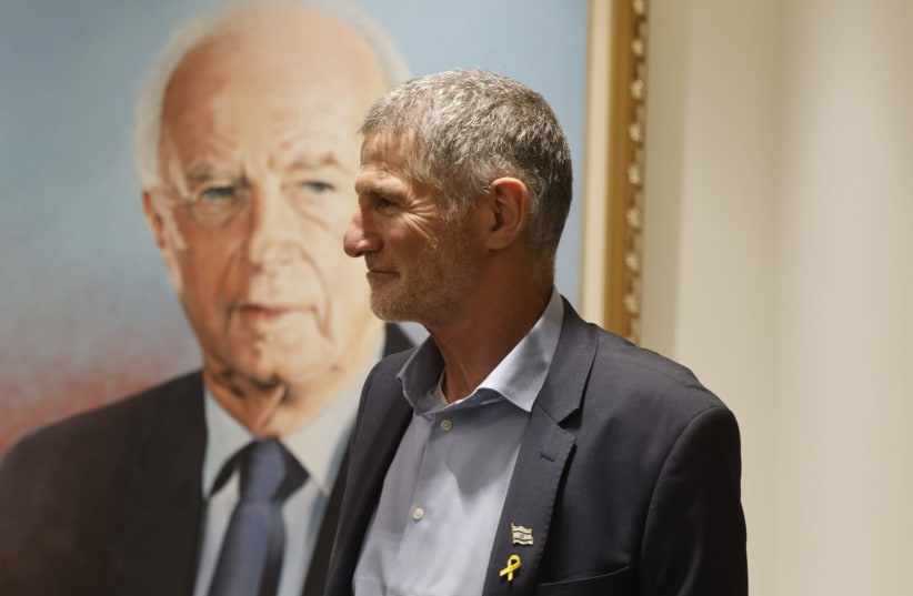  Labor leader Yair Golan poses next to a photo of former prime minister Yitzhak Rabin, June 17, 2024 (photo credit: MARC ISRAEL SELLEM)