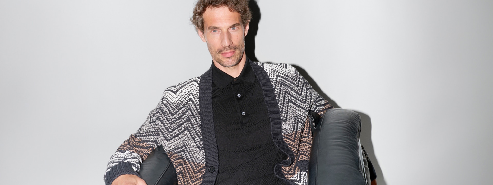 a man wears a zigzag cardigan from the new ss25 collection