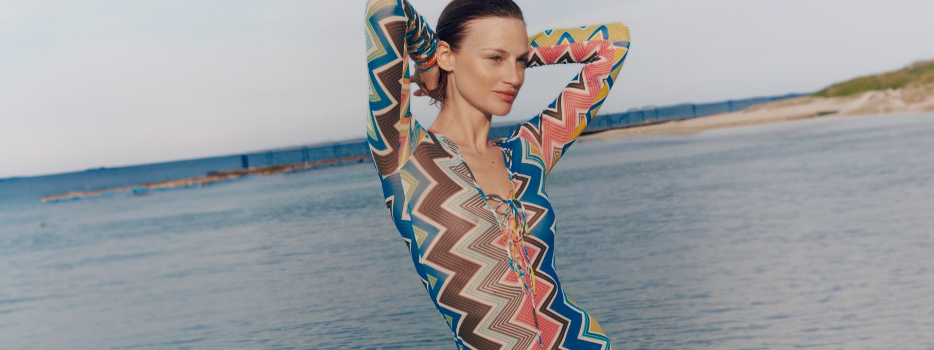 A model is wearing a multicolour zigzag cover-up from the Beachwear collection
