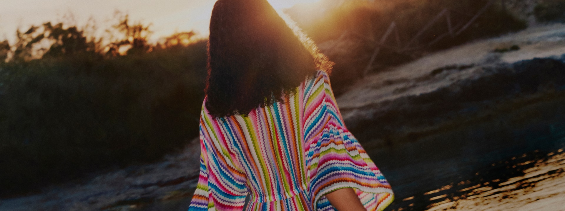 A model is wearing a multicoloured zig zag cover-up