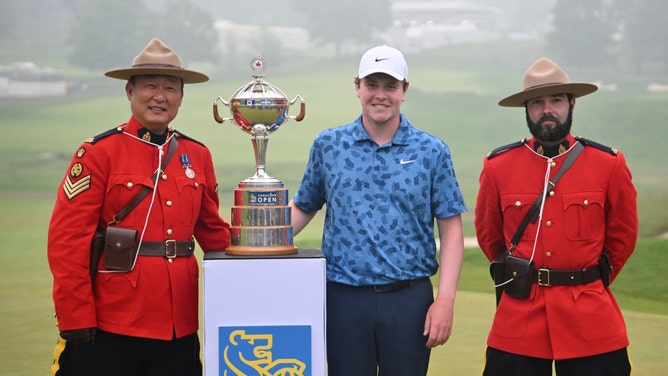 Robert MacIntyre poses with two Canadian Mounties and the trophy after winning the 2024 RBC Canadian Open. (Dan Hamilton-USA TODAY Sports)