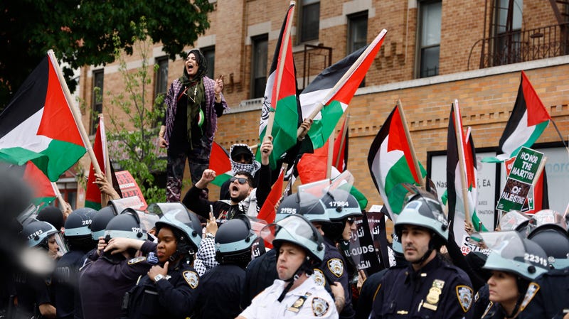 NYPD officers keep watch as hundreds of pro-Palestinian demonstrators rally on Saturday in Bay Ridge
