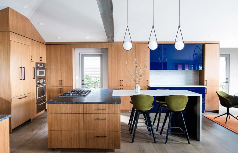 In Roger Lorenze and Dana Lorenze’s Blue Ridge kitchen, Adelaide barstools from BoConcept sit under a kitchen island in leathered Black Cosmic Quartzite and leathered Sea Pearl Quartzite. The rift-cut reclaimed teak cabinetry is covered in Rehau’s RAUVISIO high-gloss acrylic surface in Notte, and the steel backsplash is Twilight Star.