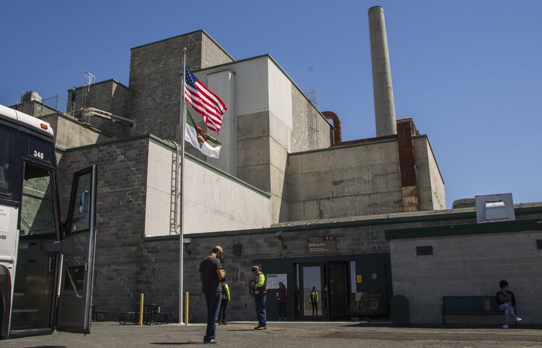 Visitors and their bus driver wait outside the B Reactor on Thursday, June 22, 2017 outside of Richland. The B Reactor was the first large-scale nuclear reactor ever built. It produced the plutonium used in the “Fat Man” bomb, dropped by the United States on Nagasaki to end the Second World War. The reactor and Hanford site recently became one of three pieces comprising the newly crowned Manhattan Project National Historical Site. Having been taken over by the National Park Service from the Department of Energy, the reactor is now open to the public on scheduled tours.   202446