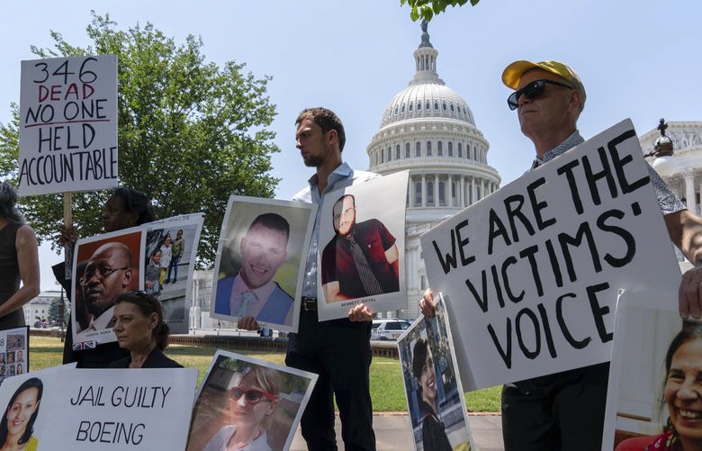 Family members of the crash victims of the Boeing 737 MAX8 in Ethiopia, hold photographs during a news conference on Capitol Hill, Tuesday, June 18, 2024, in Washington. ( AP Photo/Jose Luis Magana) DCJL111 DCJL111