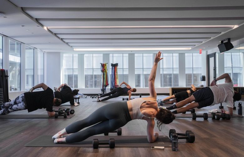 A group exercise class at Life Time, a gym that calls itself a “country club” version of a health club, in New York, Thursday, June 12, 2024. High-end gyms, many of which used to be an amenity, are now the star attraction, offering hotel rooms and workspaces as part of their appeal. They’ve also gotten a lot bigger. (Hiroko Masuike/The New York Times)