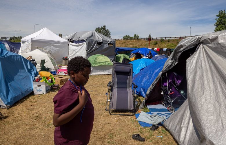 Joslin Mupepe walks along his encampment in Kent on Saturday, June 29, 2024.    227393