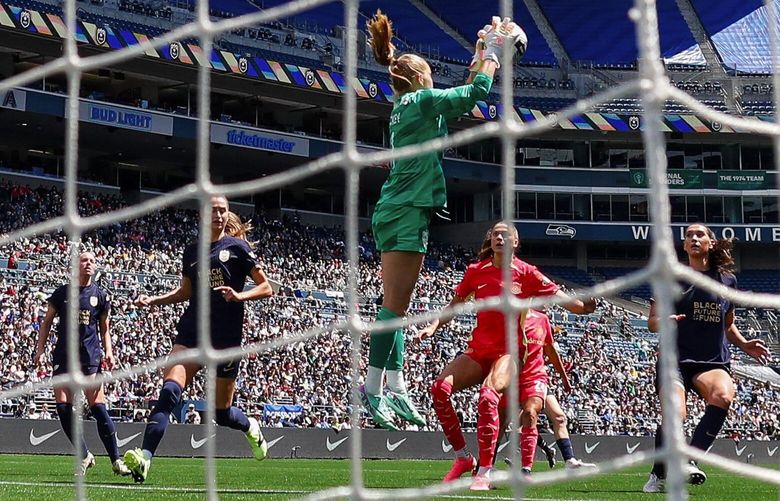 Seattle Reign FC goalkeeper Claudia Dickey pulls down a corner kick during the second half Sunday, June 16, 2024 in Seattle. 227205 227205