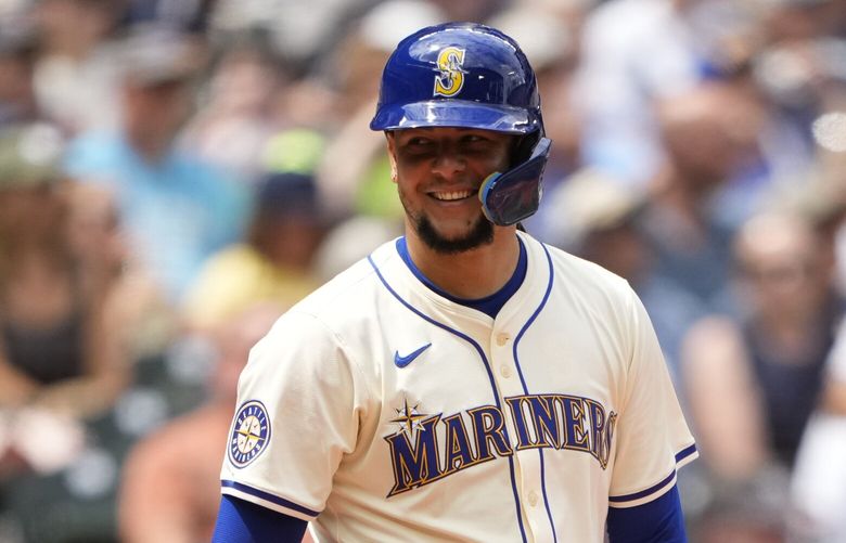 Seattle Mariners’ Luis Castillo smiles as he comes up to bat in place of Mitch Garver, who left the game during the second inning after being hit by a pitch, as Minnesota Twins catcher Christian Vázquez looks on during the fourth inning of a baseball game Sunday, June 30, 2024, in Seattle. (AP Photo/Lindsey Wasson) WALW716 WALW716