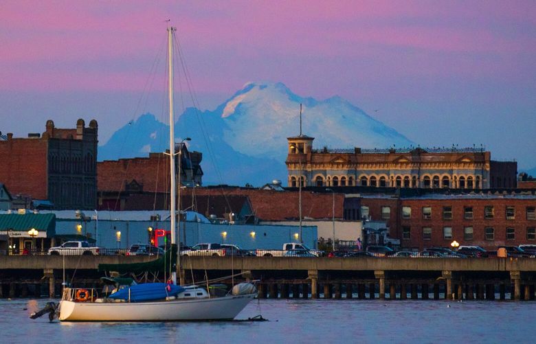 Mt. Baker looms in the distance during a colorful sunset behind downtown Port Townsend.  
Port Townsend, about an hours drive from the Kingston Ferry terminal, is a small town that features sweeping views of both the Olympic and Cascade Mountain Ranges. 

Photographed on September 4, 2019.  211245