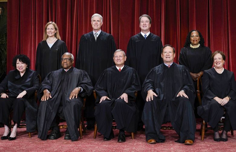 FILE – Members of the Supreme Court sit for a new group portrait following the addition of Associate Justice Ketanji Brown Jackson, at the Supreme Court building in Washington, Oct. 7, 2022. Bottom row, from left, Associate Justice Sonia Sotomayor, Associate Justice Clarence Thomas, Chief Justice of the United States John Roberts, Associate Justice Samuel Alito, and Associate Justice Elena Kagan. Top row, from left, Associate Justice Amy Coney Barrett, Associate Justice Neil Gorsuch, Associate Justice Brett Kavanaugh, and Associate Justice Ketanji Brown Jackson. (AP Photo/J. Scott Applewhite, file) WX102