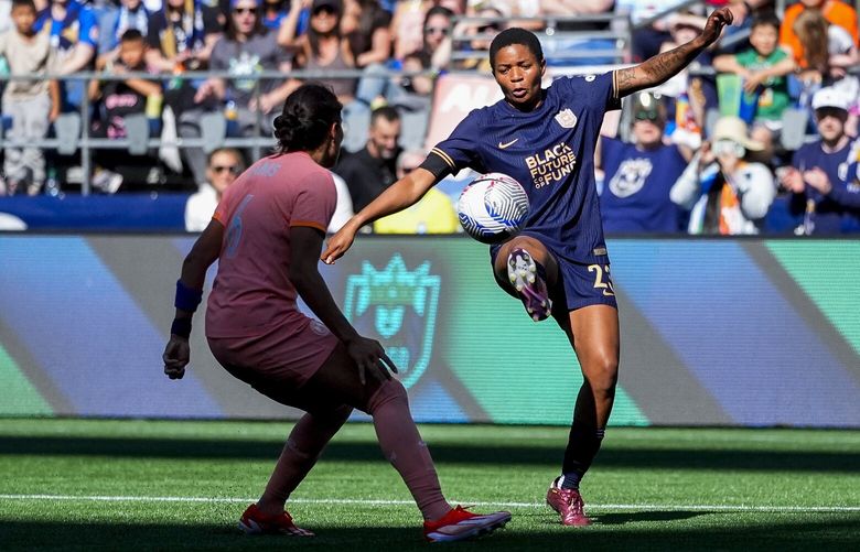 Seattle Reign forward Tziarra King (23) tries to control the ball near the goal against Orlando Pride defender Emily Sams (6) during the second half of an NWSL soccer match, Sunday, May 19, 2024, in Seattle. Orlando won 3-2. 226948