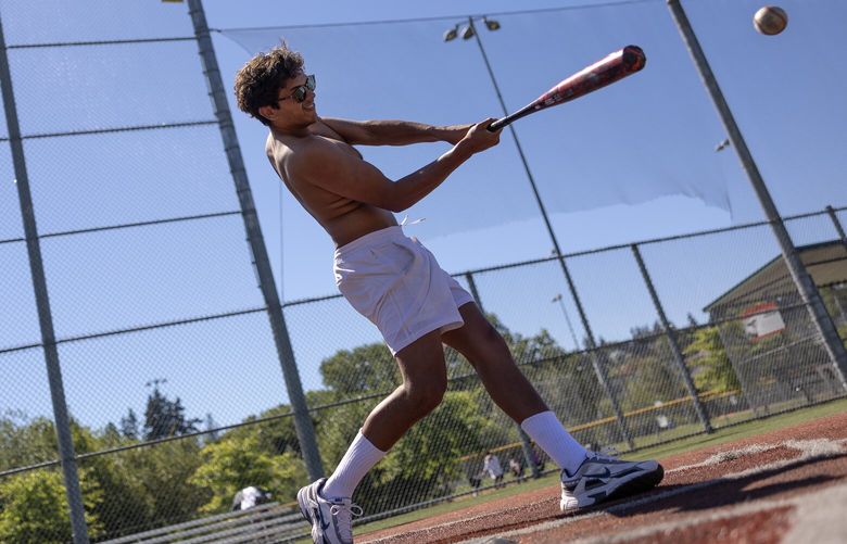 Tony Kavalam swings at a pitch while taking batting practice at Magnuson Park on Monday, July 8, 2024, in Seattle.