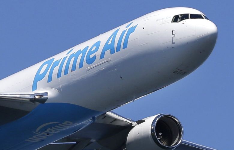 A Boeing 767 with an Amazon.com “Prime Air” livery flies over Lake Washington, Friday, Aug. 5, 2016, as part of the Boeing Seafair Air Show. Amazon unveiled its first branded cargo plane Thursday, one of 40 freighters that will make up the company’s own air transportation network of 40 Boeing jets leased from Atlas Air and Air Transportation Services Group, which will operate the air cargo network. (AP Photo/Ted S. Warren) OTK